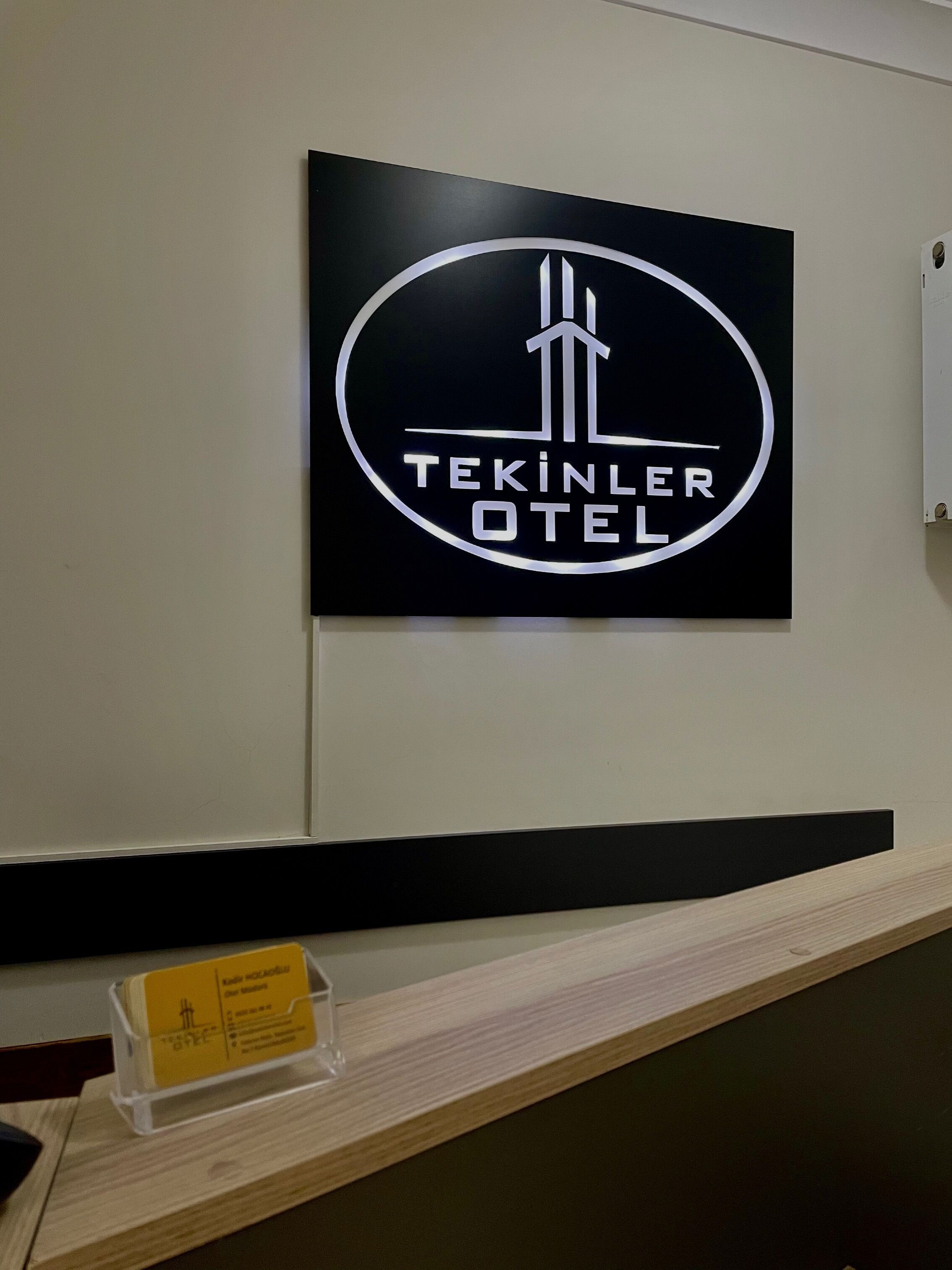 A sign with the text "TEKINLER HOTEL" on a wall.