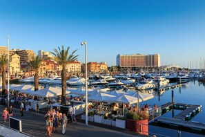 Enjoy waterfront dining and socializing at this bustling marina, surrounded by boats and scenic views.