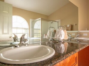 A bathroom with a large mirror, two sinks, and a granite countertop. - 3 Bed 258 (Kissimmee)