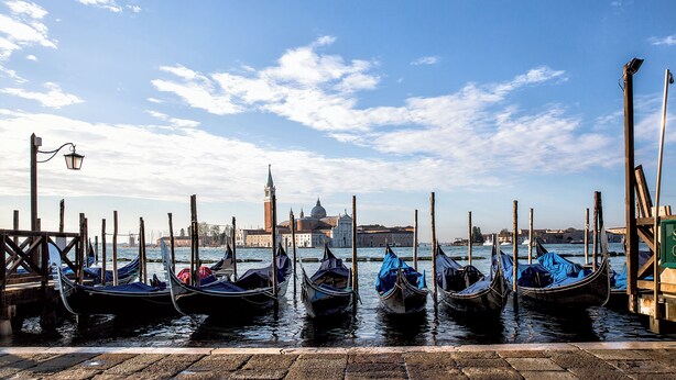 Gondolas docked at a pier with a historic building in the background. - SARA'S LUXURY HOME 5 minutes from St Mark's Square (Venice)