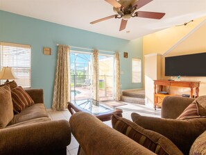 House (Private Screened Splash Pool Overlook) | Living room | Flat-screen TV - Private Screened Splash Pool Overlooking Tranquil Lake Right Beside Disney World by Florida Dream Homes (Kissimmee)