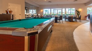A pool table in a room with a carpeted floor, a door, and a window. - Private Screened Splash Pool Overlooking Tranquil Lake Right Beside Disney World by Florida Dream Homes (Kissimmee)
