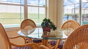 A glass-top table with wicker chairs and a potted plant. - 4 Bed 2269 (Kissimmee)