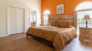 A bedroom with a large bed, a nightstand, a lamp, and a window with a view. - 3 Bed 156 (Davenport)