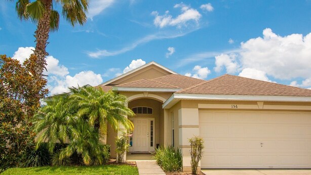 A single-story house with a beige facade, a brown roof, and a garage numbered 156. - 3 Bed 156 (Davenport)