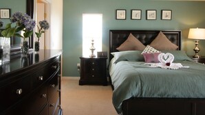 A bedroom with a bed, dresser, nightstand, lamp, and wall art. - 5 Bed 722 (Davenport)