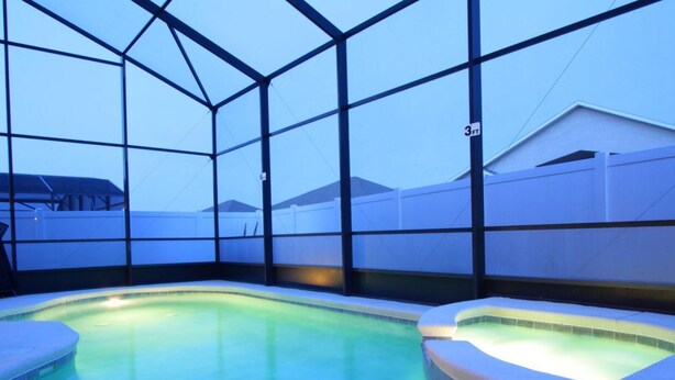 An indoor swimming pool with clear blue water, surrounded by a metal frame structure. - 5 Bed 722 (Davenport)