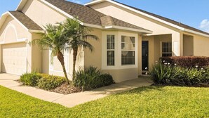 A single-story house with a garage, a front porch, and a well-maintained lawn. - 4 Bed 428 (Davenport)