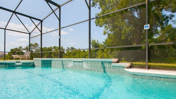 An indoor swimming pool with clear blue water, surrounded by a metal frame structure. - 5 Bed 388 (Davenport)