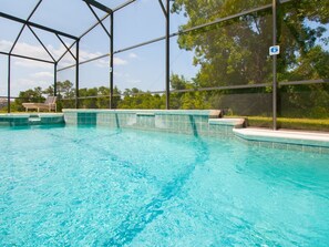 An indoor swimming pool with clear blue water, surrounded by a metal frame structure. - 5 Bed 388 (Davenport)