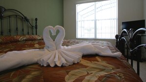 A hotel room with a bed, a large window, and a television on the wall. - 5 Bed 4720 (Kissimmee)