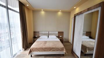 Premium bedding, desk, laptop workspace, blackout drapes