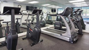 A gym with multiple treadmills, stationary bikes, and elliptical machines. - The Enclave - Crd409 (Orlando)
