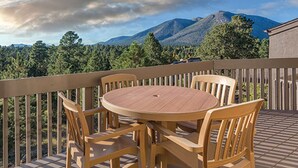 A wooden deck with a round table and chairs, overlooking a mountainous landscape. - 1BD/Flagstaff w/Full Kitchen, W/D, Sleeper Sofa & Amazing Amenities!! (Flagstaff)