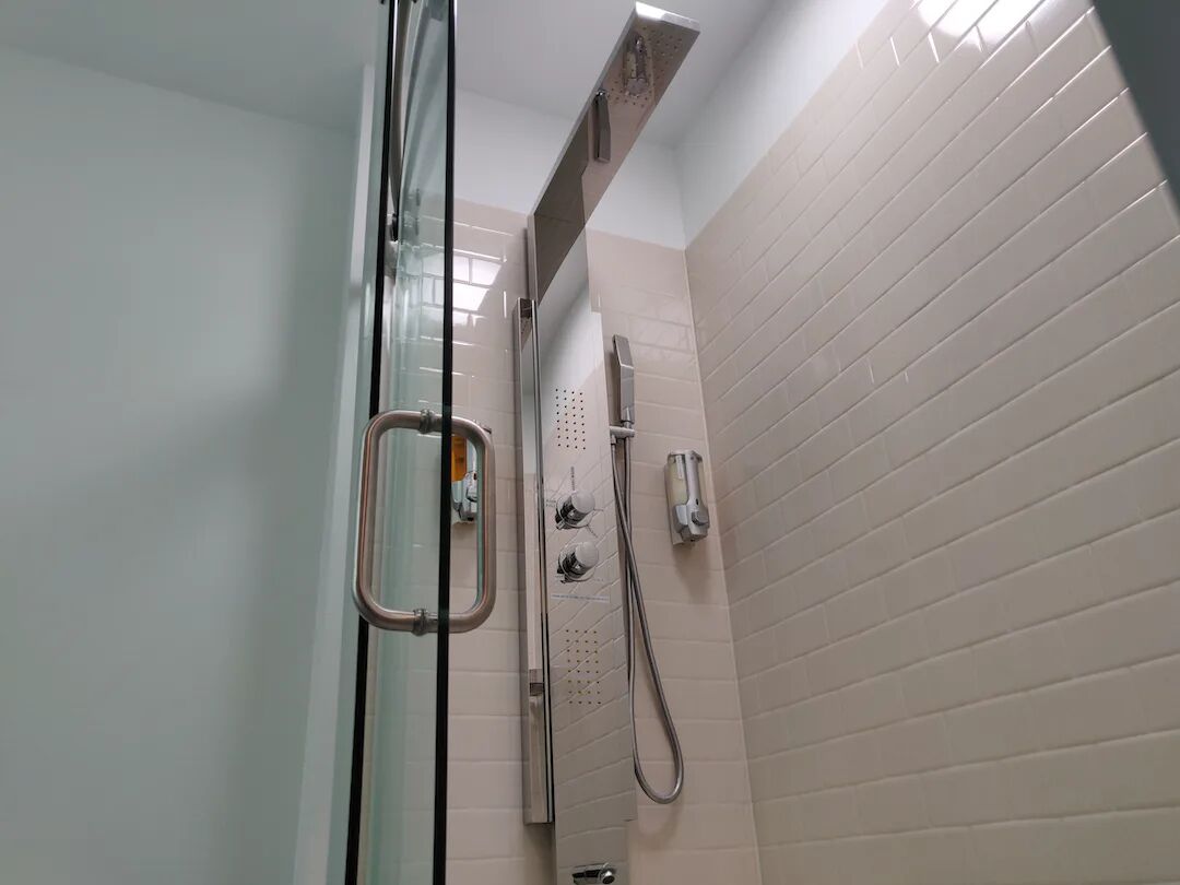 luxurious room w/ two queen beds, 65'' tv, complimentary drinks - non-smoking | bathroom | shower, hydromassage showerhead, designer toiletries, hair dryer