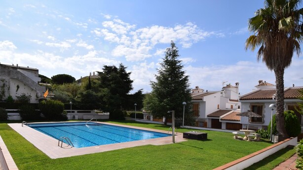 A swimming pool surrounded by a well-maintained lawn, with a clear sky above. - Voramar CostaBravaSi - Pool, BBQ, views, wifi (S'Agaró)