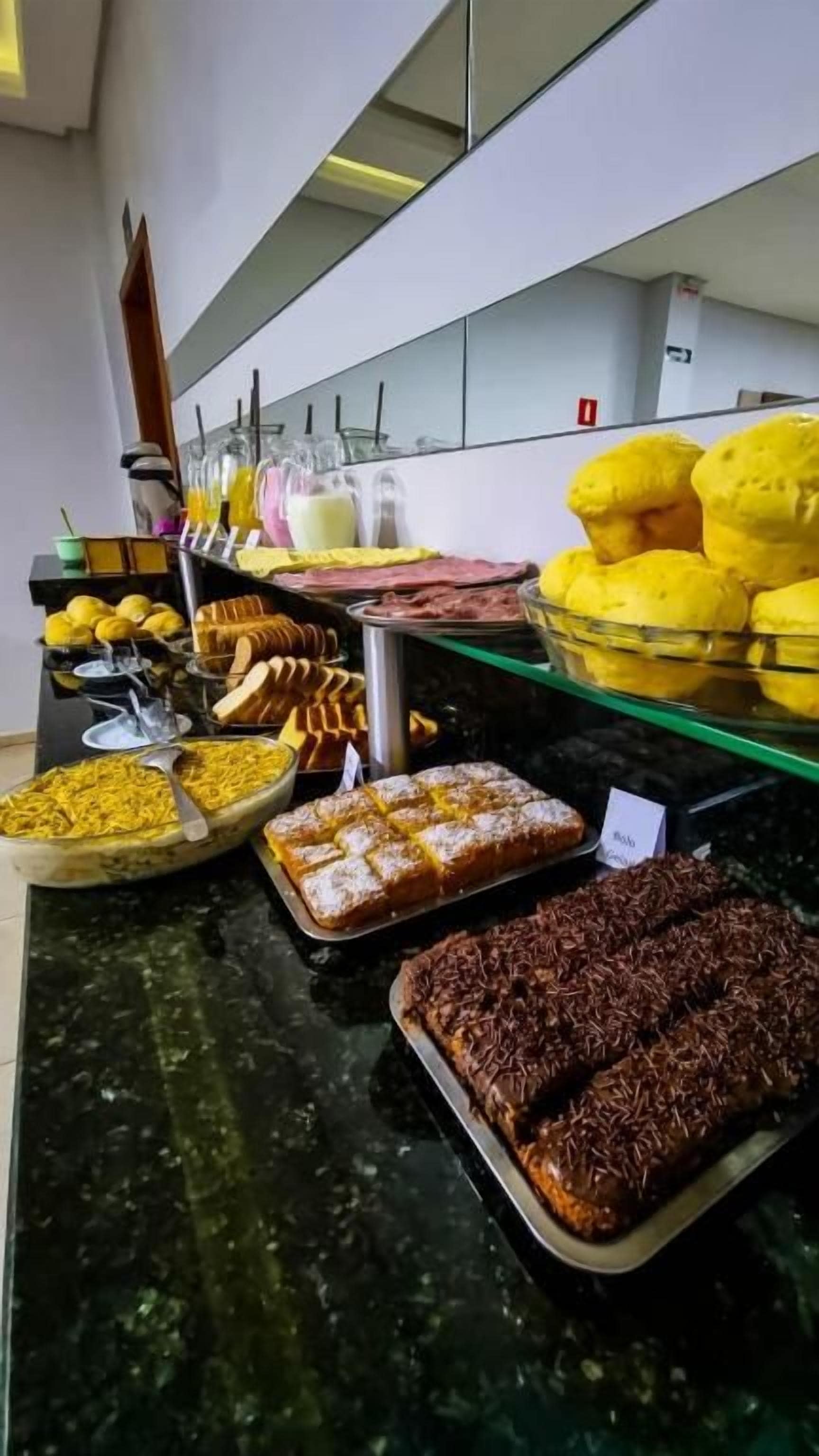 A buffet with various food items and beverages.