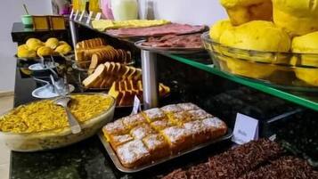 A buffet with various food items and beverages.