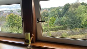 A window with a view of a residential area and trees. - Glasgow Emo (Glasgow)