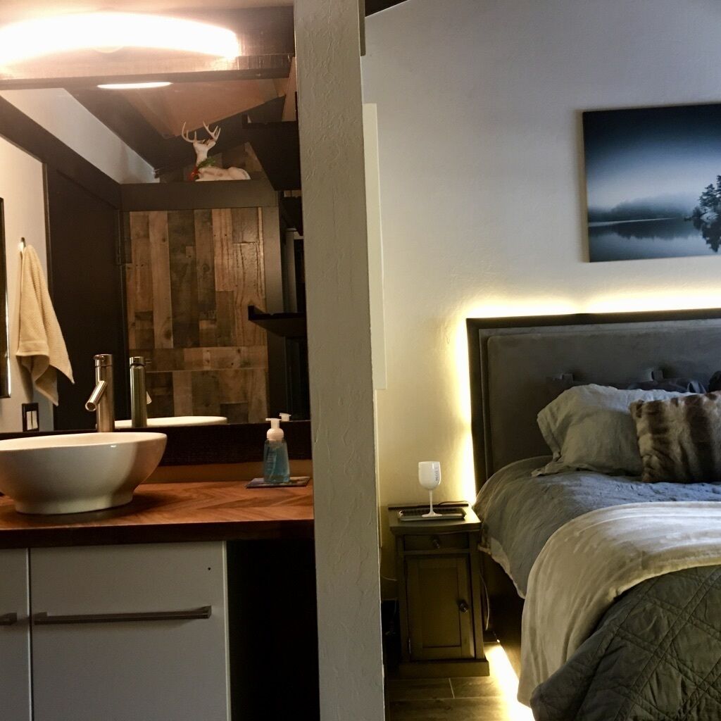 Ein modernes Badezimmer mit einem Holzlagerflansch, einem großen Waschbecken und einem Spiegel.