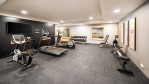 A gym with treadmills, stationary bikes, and weight machines.