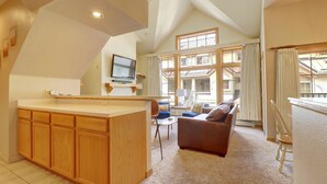 A spacious living area with a kitchen, a sofa, and a television. - Pet Friendly, Slope-side, Spacious Town Home  ER21 (Copper Mountain)