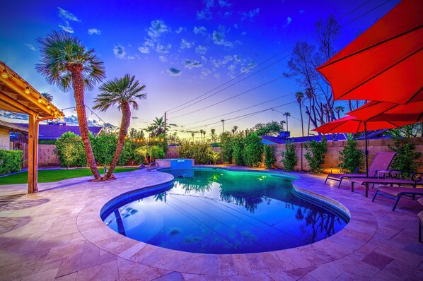 A swimming pool with a curved design, surrounded by palm trees and lounge chairs. - Near ASU • Private Pool, Hibiscus Hot Tub • Firepit • BBQ • Spring Training (Tempe)