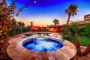 A hot tub surrounded by a pool, palm trees, and outdoor seating. - Near ASU • Private Pool, Hibiscus Hot Tub • Firepit • BBQ • Spring Training (Tempe)