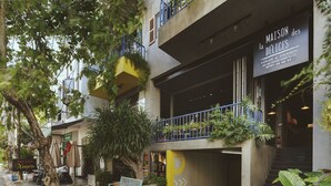 A multi-story building with a sign for Maison des Délices. - La Maison Des Delices (Da Nang)