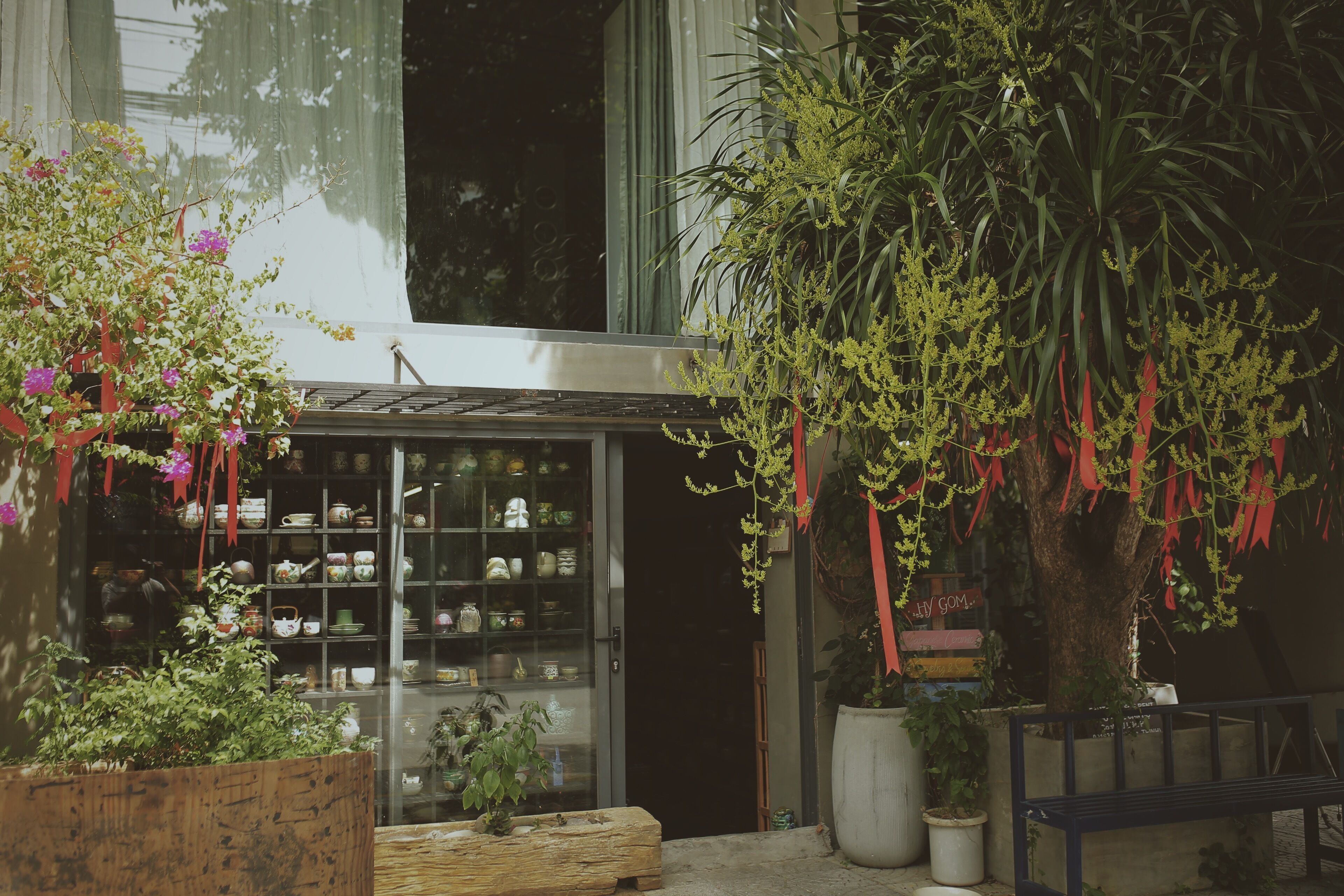A storefront with glass display cases filled with various items.