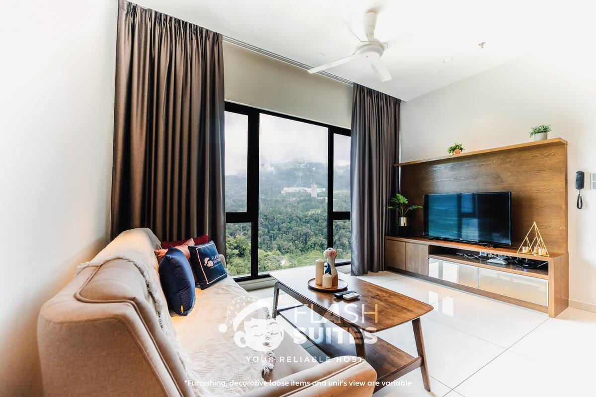 A modern living room with a sofa, coffee table, and a TV against a wooden wall.
