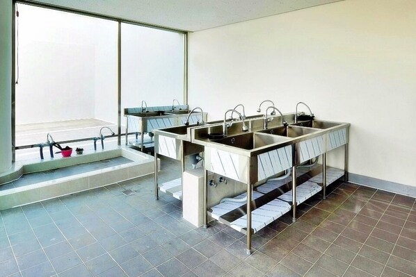 A modern bathroom with a large window, a double sink, and a shower area.