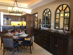 Enjoy meals in this stylish dining area with a dark wood table and comfortable chairs.