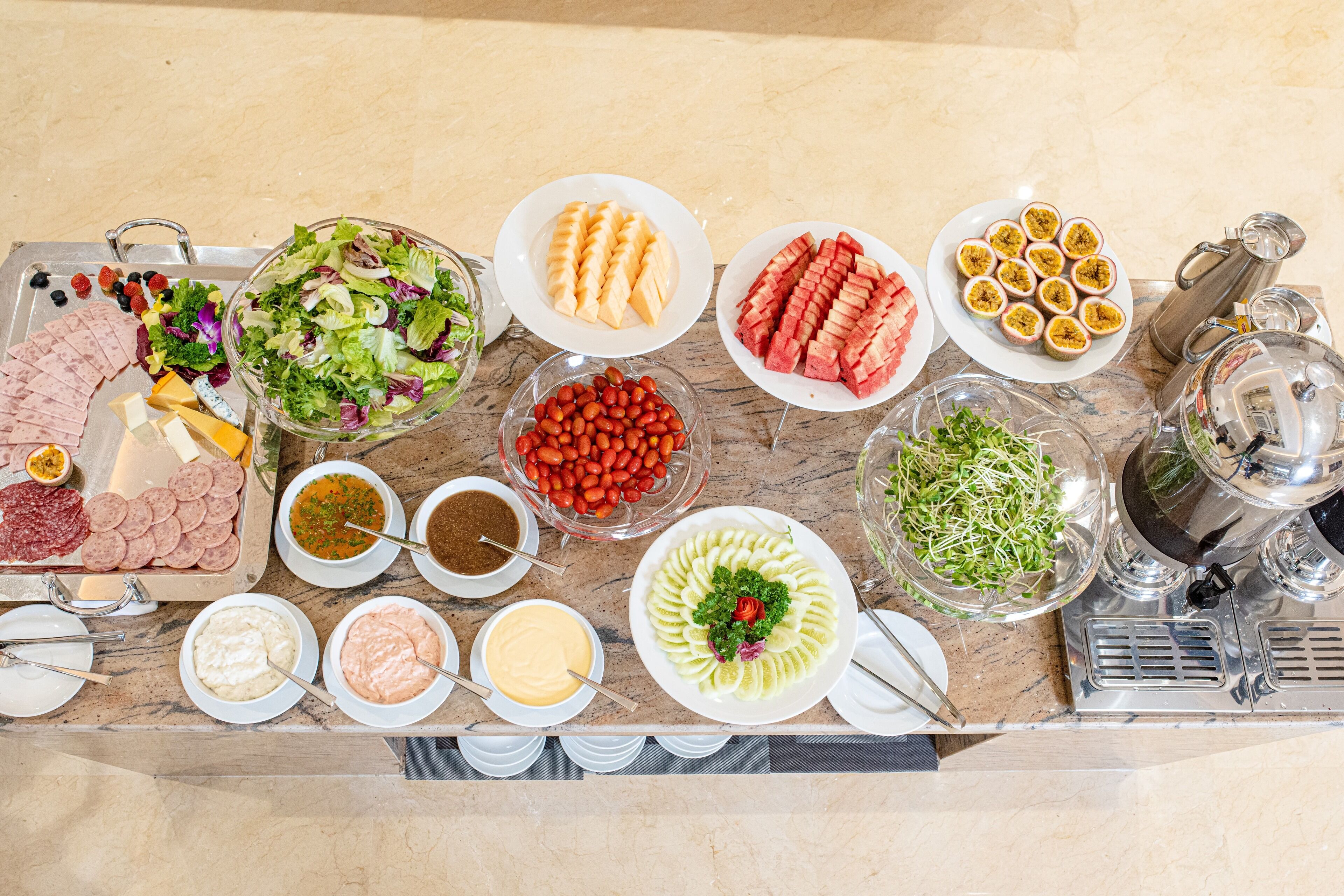 A buffet table with various food items and beverages.