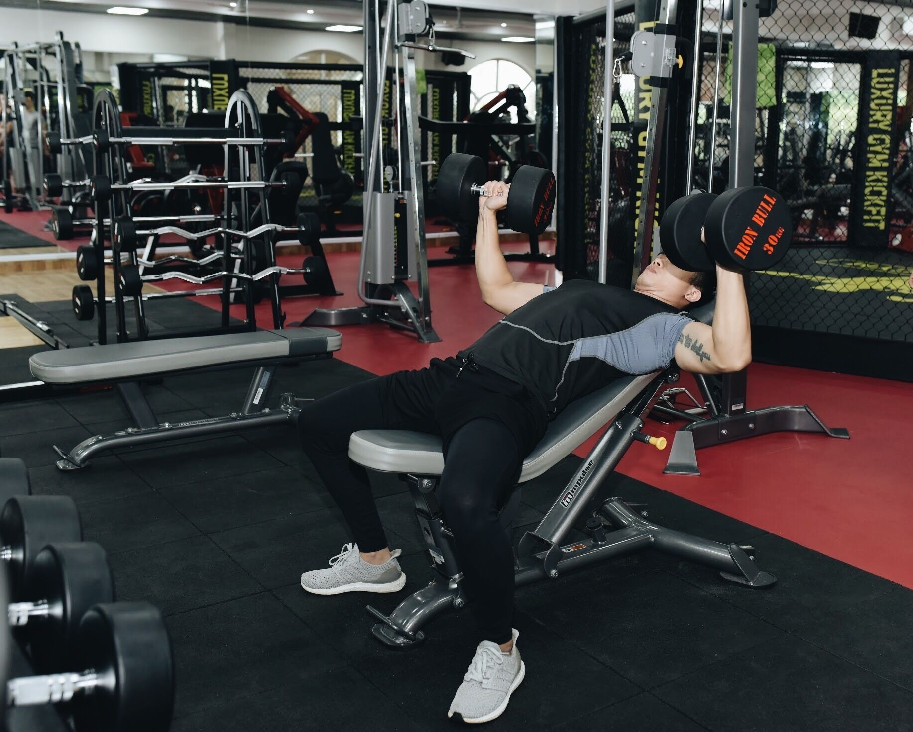 A gym with various exercise equipment, including dumbbells and weight machines.