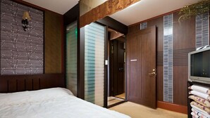 A bedroom with a bed, a television, and a wardrobe. - Taean White Sand Pension (Taean)