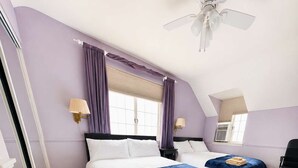 A hotel room with two beds, a ceiling fan, and a window with curtains. - Spacious 4BR CozySuites in Old Town Alexandria (Alexandria)