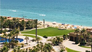 Ein Resort mit Pool, Palmen und Strand.