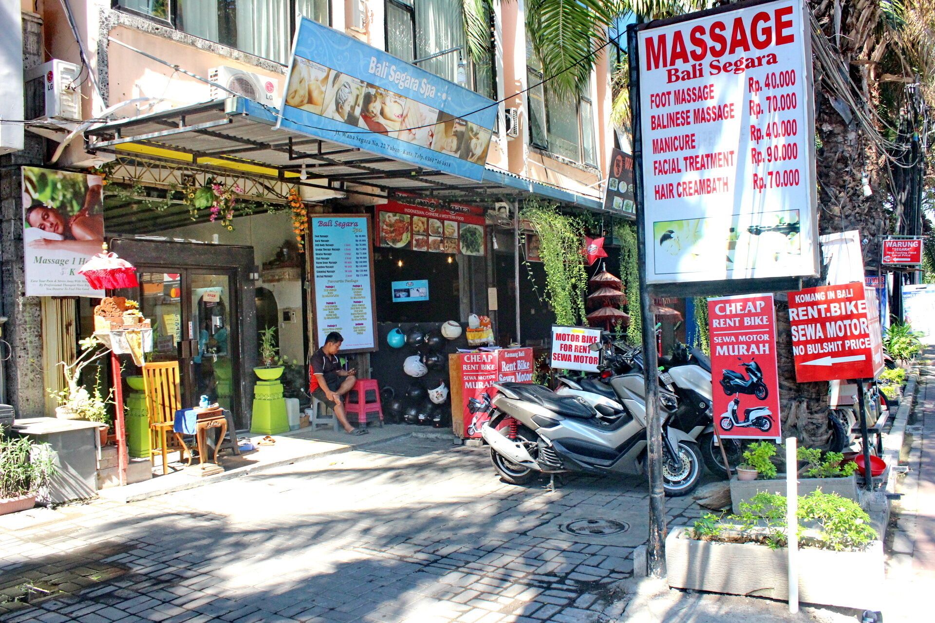 A massage parlor with a sign listing services and prices.