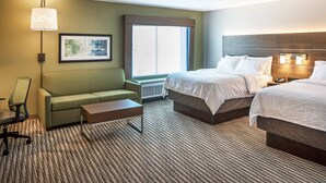 A hotel room with two beds, a sofa, a desk, a lamp, and a framed picture on the wall. - Holiday Inn Express & Suites West Omaha - Elkhorn by IHG (Elkhorn)