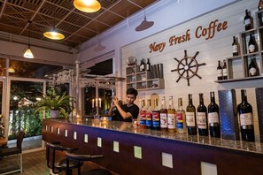 A bar area with a sign reading "Navy Fresh Coffee" and various bottles of wine and spirits. - Navy Hotel Da Lat (Lam Vien - Da Lat)