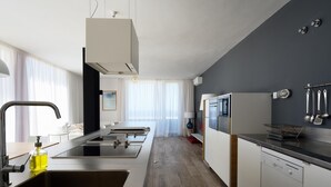 A modern kitchen with a central island, stainless steel appliances, and a dishwasher. - Luxe Loft Casa Atlantica Morro Jable 658 BY PVL (Morro Jable)