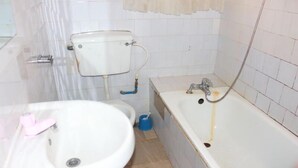 A bathroom with a sink, toilet, and bathtub.