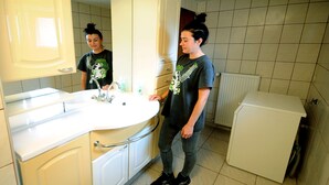 A bathroom with a white sink, a mirror, and a white cabinet. - Baka Ljuba (Kutjevo)
