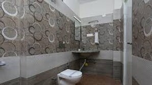 Un baño con inodoro, lavabo y espejo.