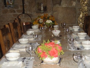 Enjoy a romantic meal at this elegant dining table, set with fine china and a beautiful floral centerpiece.