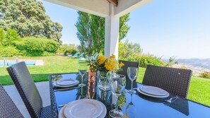 A table set for four with a clear view of the outdoors.