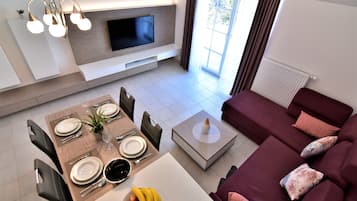 Luxury Apartment | Living area | 50-inch LED TV with cable channels, TV, ping pong