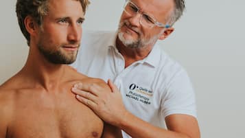 A man receiving a physical examination from a healthcare professional.