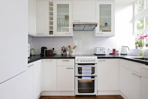 Three-Bedroom Apartment | Private kitchen | Full-size fridge, microwave, oven, stovetop